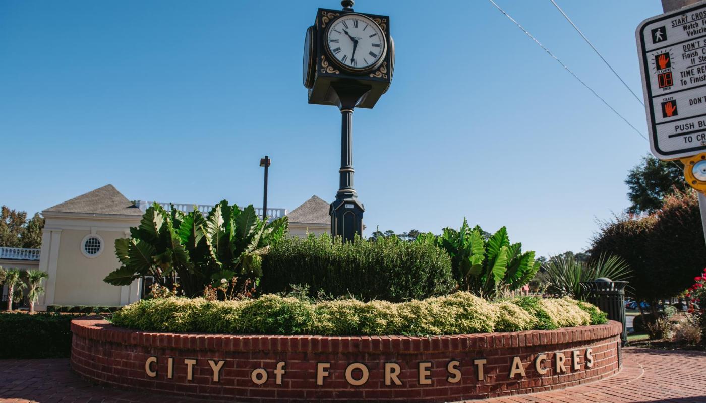 The city clock tower at the intersections of Forest Drive and Trenholm Road.